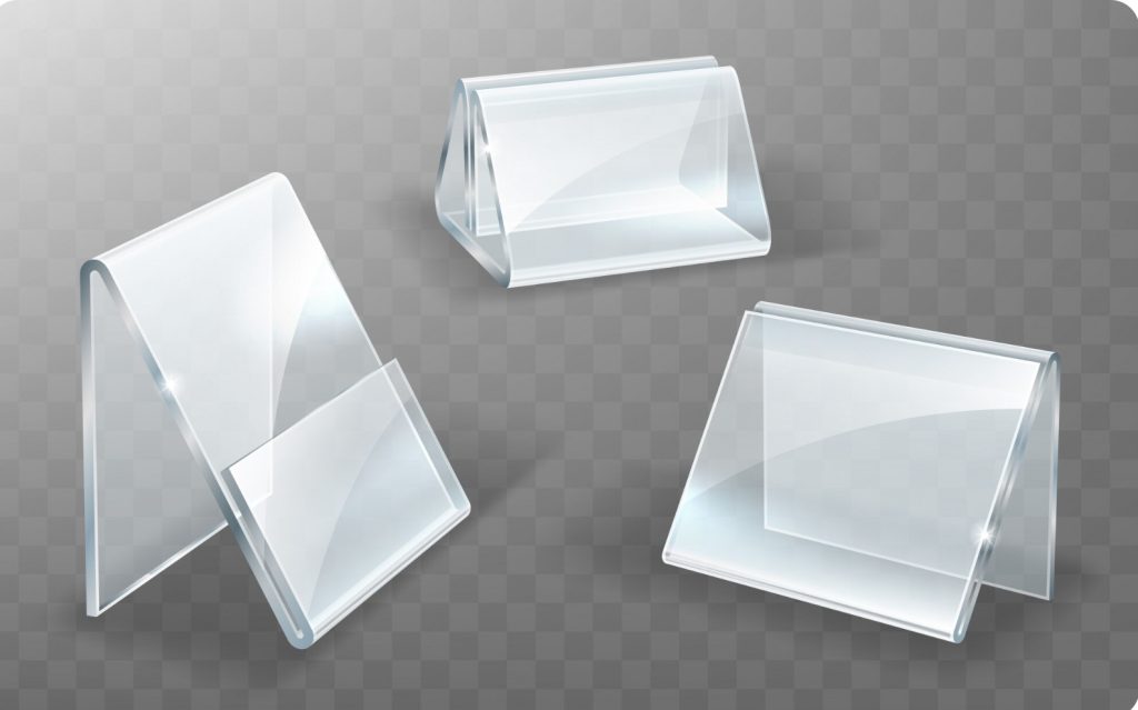 Three clear glass display panels angled and floating over a gray checkered background, showing beveled edges and reflections.