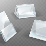 Three clear glass display panels angled and floating over a gray checkered background, showing beveled edges and reflections.