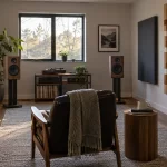 Listening room with fabric absorbers and a geometric wooden diffuser around a stereo setup