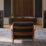 Symmetrical stereo speakers and a listening chair arranged in a measured home audio room